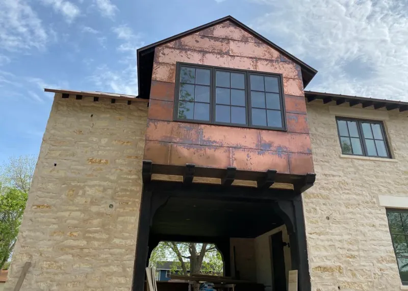 Copper metal panel facade on a stone building for Skylight Installation in Cary