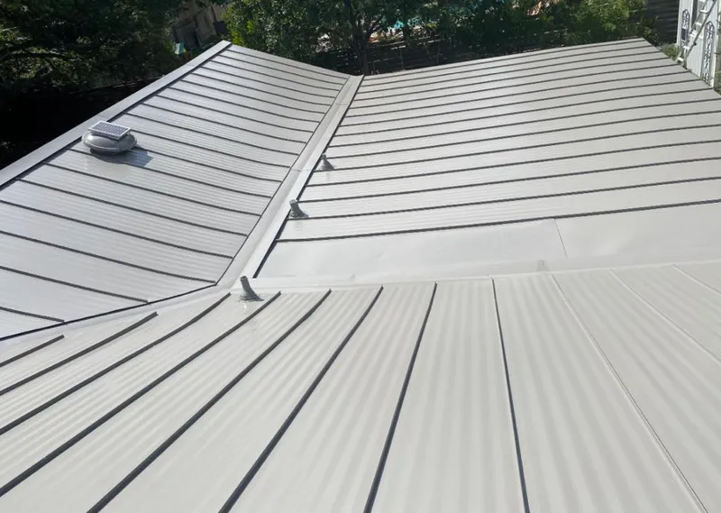 Solar attic fan installed on a metal roof for Roof Ventilation in Cary